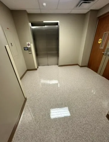Elevator lobby with a freshly cleaned floor