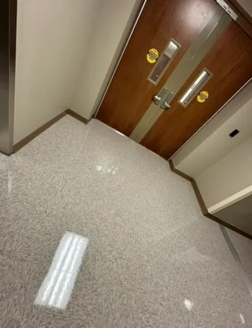 Clean entryway floor by a set of wood doors